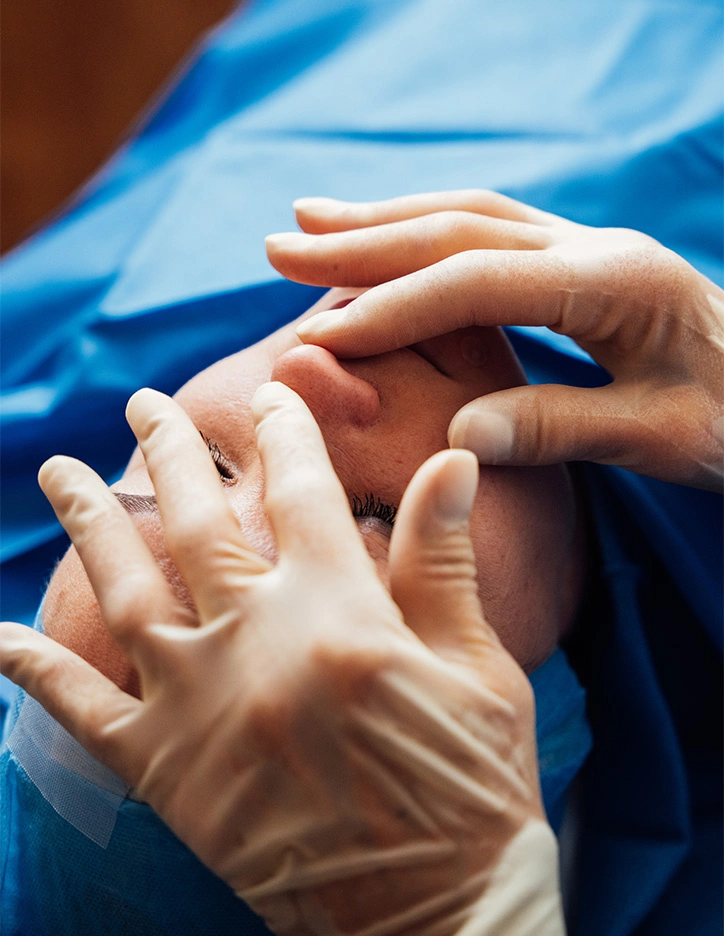 Healthcare professional in gloves performing a nasal tip refinement surgery