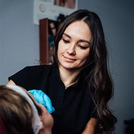 Healthcare professional examining patient with blue medical gloves in clinical setting